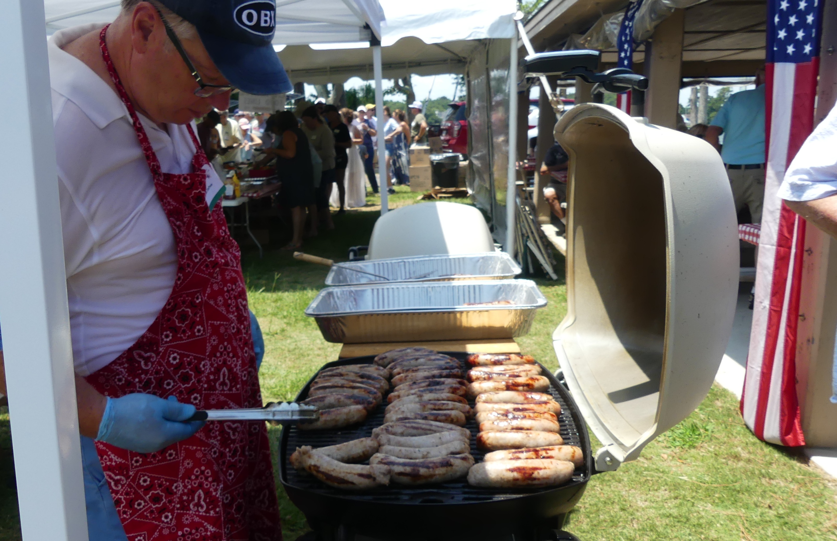 Brats A member grills brats at the Independence Day BBQ